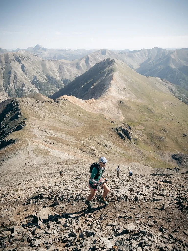 Hiker climbing Handies Peak